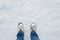 Winter shoes footprint in fresh snow, blue jeans trousers, copyspace