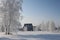 Winter in Siberia snowy white trees in snowdrifts beautiful houses in the village of rime