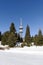 Winter ski resort Pamporovo, Bulgaria. High spruce trees, snow and TV Snezhanka tower. Winter holidays. Horizontal