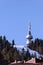Winter ski resort Pamporovo, Bulgaria in Rhodope mountains. High spruce trees, ski slope and landmark TV Snezhanka tower