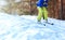 Winter skier teenager in sportswear skiing over snow at forest
