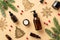 Winter skin care concept. Top view photo of amber glass bottles without label cream jar christmas tree ornaments mistletoe berries