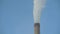 Winter sky. Steam from the cooling tower of a thermal electric water supply station. Smoke from the chimney.