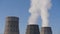 Winter sky. Steam from the cooling tower of a thermal electric water supply station. Smoke from the chimney.