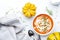 Winter slow food. Pumpkin carrot soup with cream, seeds and thyme.. Healthy diet food. White soup bowl on gray table background.