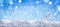 Winter snow background with decorative snowflake against blue sky. Banner format. Beautiful wintertime holiday scene