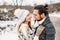 Winter snow couple love story. Beautiful girl in cozy hat and handsome bearded man hugs each other. pullover with