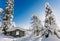 Winter snow covered wood hut. Frozen log cabin in Finland