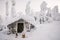 Winter snow covered wood hut. Frozen log cabin in Finland