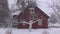 Winter snow falling and farm house