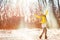 Winter snow fun woman playing throwing snow celebrating cold weather. Girl in yellow outerwear gloves, boots, hat, scarf, coat,