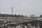 Winter snow on heather moorland, bare trees in distance and pylons / electricity wires