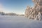 Winter snow landscape. Blue sky background. Snowy trees. The village is in rural countryside in the woods. Typical traditional