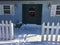 Winter snow piled up in front of green door