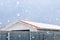 Winter and snowfall over the roofs of village cottages.