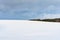 Winter snowfield and cloudy sky with large clouds, winter nature