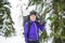 Winter snowshoeing. Young outdoorswoman hiker holding snowshoes outside in the snow