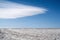 Winter snowy landscape with lenticular clouds