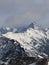 Winter Snowy Mountain. Mountainside Covered by Snow. Cloudy Sky.