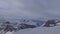 Winter snowy mountains timelapse, fast going clouds at sunny day