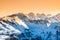 Winter snowy peaks of Alps. Mountain panorama illuminated by sunset at evening time. Austria and Switzerland, Europe