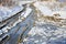 Winter snowy road through frozen forest