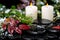 winter spa still life of evergreen branches, red leaves with drops, snow, candles on zen basalt stones, closeup