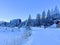 A winter sport cross-country ski trail around a frozen alpine Heidsee lake (Igl Lai lake) in the resort of Lenzerheide