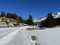 A winter sport cross-country ski trail around a frozen alpine Heidsee lake (Igl Lai lake) in the resort of Lenzerheide