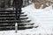 Winter. Stairs. People walk on a very snowy stairs. Uncleaned icy stairs in front the buildings, slippery stairs.