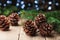 Winter still life with pine cones and fir tree on vintage wooden table. Holiday greeting card.