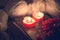 Winter Still life with a rowan berries, knitted sweater and a two red candles on a old book as a symbol of love and together