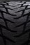 Winter studded car tire on grey background