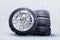 winter studded tires, a set of friction winter wheels with aluminum alloy wheels on a white background. falling snow is