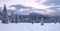 Winter sunrise panorama. A landscape of high mountains with a snow white peak. Forest. The lawn is covered with snow and the path