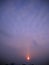 Winter sunset and cloudscape over roofs covered with snow