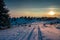 Winter sunset over dirtroad on the top of the mountain