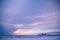 Winter Sunset over Snowy American Corn Fields in Winter with Cloudy Sky.