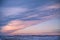 Winter Sunset over Snowy American Corn Fields in Winter with Cloudy Sky.