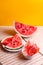 Winter supplies: slices of dried watermelon with fresh pieces on yellow background