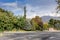 Winter Tehran street view in Tehran International Exhibition Center with snow covered Alborz Mountains against cloudy sky on