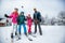 Winter time and skiing - family with ski and snowboard on ski ha