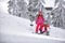 Winter time and skiing - mother preparing daughter on ski resort