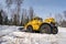 Winter time. Snowplow working in woods