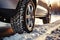 Winter tire close up on a car wheel navigating snowy road