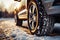 Winter tire close up on a car wheel navigating snowy road