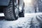 Winter tire. Detail of car tires in winter on the road covered with snow.