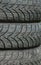 Winter tires close-up . Tyre background. Tire stack background