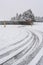 Winter tires traces on snowy road turn with stop sign in front