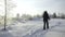 Winter track for skiers . Creative . People walking on skis in the winter snow-covered forest next to bare trees and